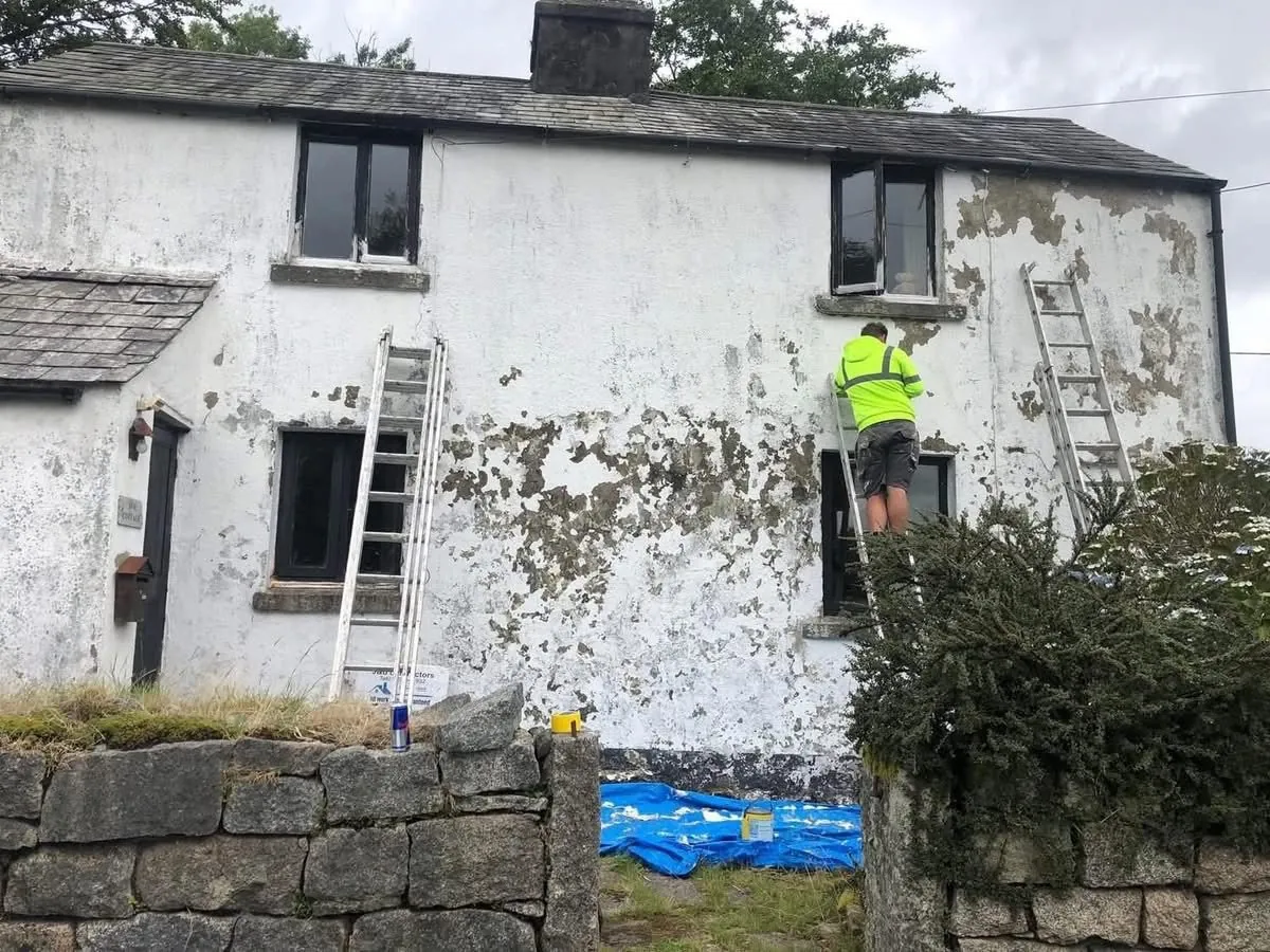 Cottage with blown, flaking render before repair in Budleigh Salterton